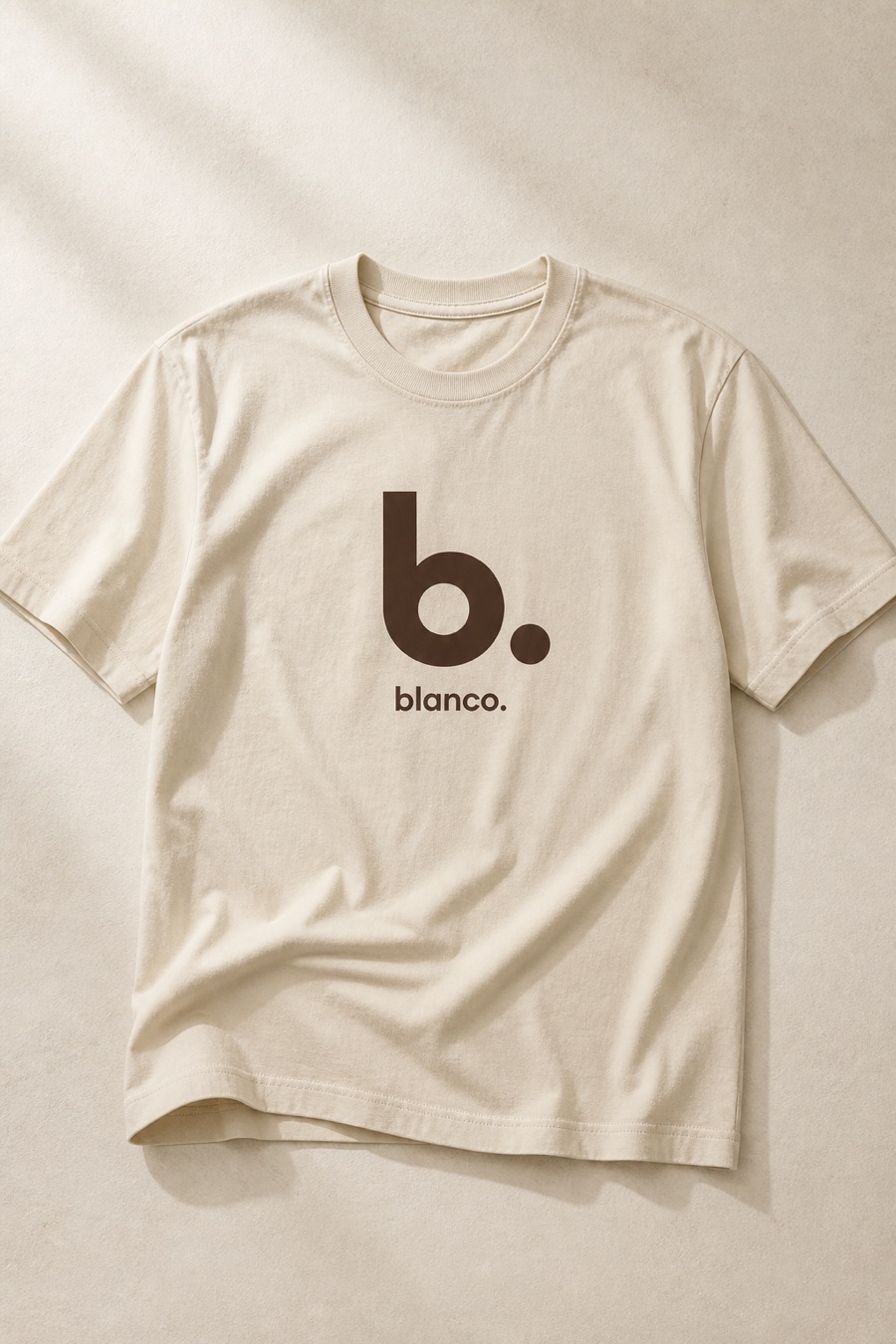 A cream Blanco tee with the geometric b. and blanco. wordmark.